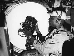 B-29 gunner operating scanning gunsight.
